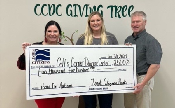 $2,500 donation to Colt&#039;s Corner Daycare Center to purchase daycare items for children with autism. Pictured are FCB employees Sarah T and Gene R with director Maya V.