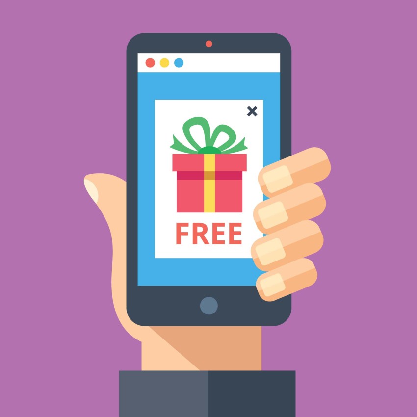 Hand holding a phone with a screen that displays "Free " and a present.